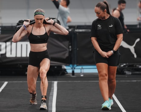 Joanna Wietrzyk carries a heavy sandbag on her shoulders while running at Hyrox Beijing